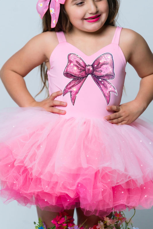 Pink glitter coquette bow image on a one piece pink ombré with glitter soft tulle